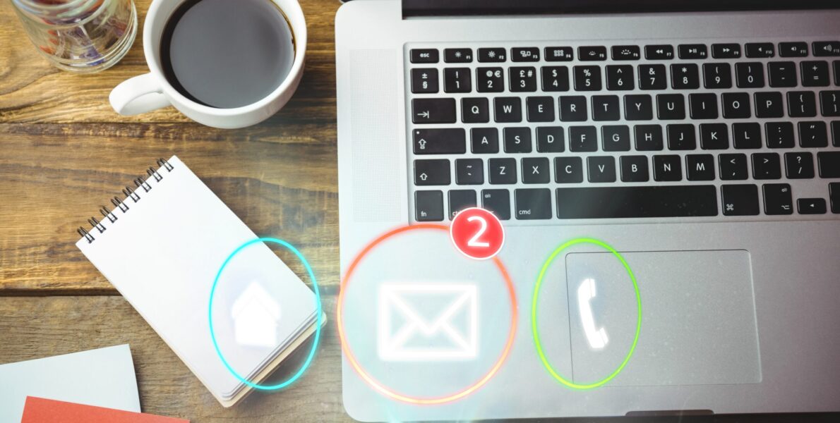 Composite image of laptop, notebook and coffee on a desk with contact icons